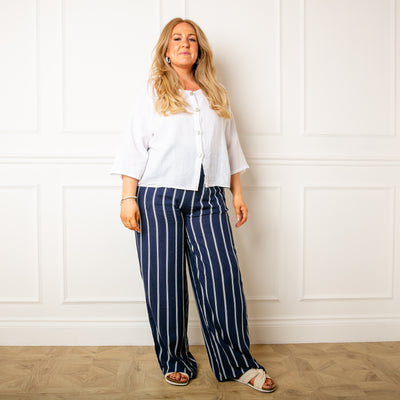 Model wearing the navy blue Pinstripe Linen Trousers in Medium/Large